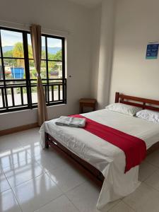 a bedroom with a bed and a large window at Hotel morada del sol 