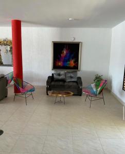 a living room with a couch and two chairs at Hotel morada del sol 