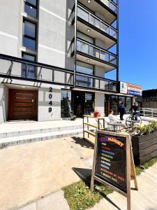 a building with a sign in front of it at Refugio Valdiviano - Tu descanso junto al rio in El Cerrillo