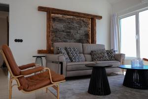 a living room with a couch and a table at FLH Funchal Bay View Escape with Pool in São Gonçalo