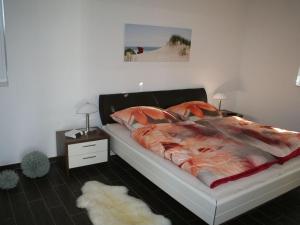 a bedroom with a bed and a table with a night stand at Villa Kiek Ut in Trent