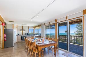 a kitchen and dining room with a table and chairs at Ocean Vista Large Modern Home With Ocean Views in Guilderton