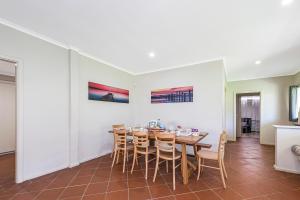 a dining room with a table and chairs at Coastal Pine in Guilderton
