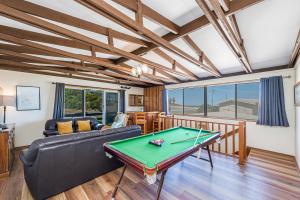 a living room with a pool table at Coastal Pine in Guilderton