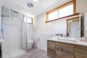 a bathroom with a sink and a shower at Coastal Pine in Guilderton +21 photos