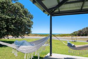 a hammock in a field with a view of the ocean at Buena Vista in Guilderton