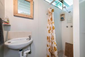a bathroom with a sink and a shower curtain at Buena Vista in Guilderton +24 photos