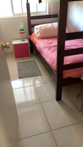 a bedroom with a bunk bed and a tiled floor at Departamento Costa Algarrobo Norte in Mirasol +12 photos