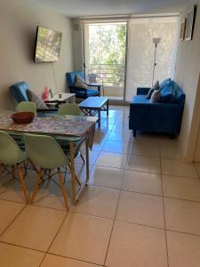 a living room with a couch and a table and chairs at Departamento Costa Algarrobo Norte in Mirasol