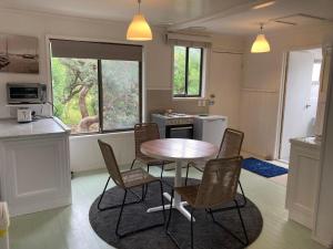 a kitchen with a table and chairs in a room at 93 Atherton in Evergreen