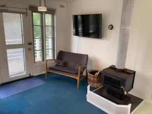 a living room with a chair and a stove at 93 Atherton in Evergreen