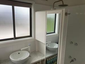 a bathroom with two sinks and a shower and a mirror at 93 Atherton in Evergreen +10 photos