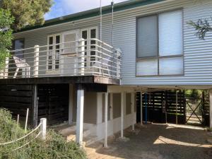 a house with a porch and a balcony at 93 Atherton in Evergreen