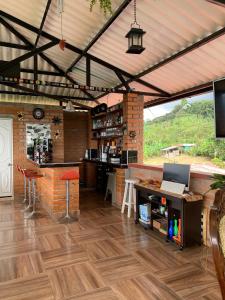 a restaurant with a bar with a laptop on a counter at Villa Pospon in Buga