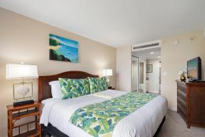 a bedroom with a large bed and a television at Kaanapali Shores 527 · KS 527 2Bedroom w Ocean Views in BeachFro in Kahana +42 photos