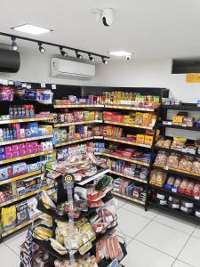 a grocery store aisle with shelves of food at Quarto privativo in São-José-do-Ribamar