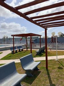 a playground with benches and a pavilion at Quarto privativo in São-José-do-Ribamar