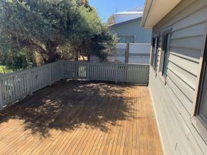 une terrasse couverte d'une maison avec une terrasse en bois dans l'établissement Centre31, à Evergreen