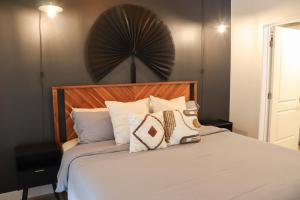 a bedroom with a bed with pillows on it at Bright & Cozy Getaway with Pool Free Parking 10 mins Disneyland in Tustin +64 photos