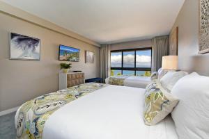 a bedroom with two beds and a large window at Kaanapali Alii 385 · ALII 385 Corner 2BD OceanFront Dream Vacati in Kaanapali +59 photos