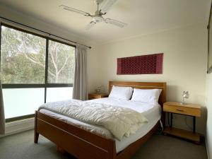 a bedroom with a bed and a large window at Condon 53 in Evergreen