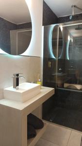 a bathroom with a white sink and a mirror at Anima Lodge in Villa Carlos Paz