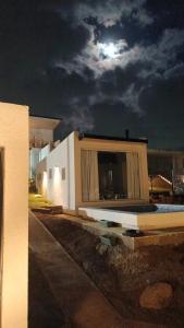 a building with the moon in the sky at Anima Lodge in Villa Carlos Paz