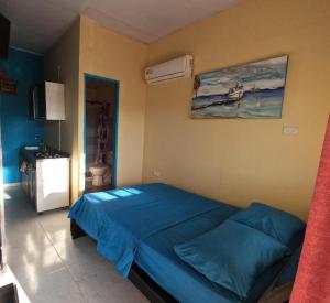 a bedroom with a blue bed in a room at Ann Dor #3 in San Andrés