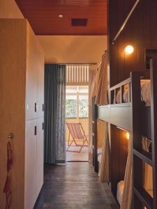a small room with a bunk bed and a chair at Halse Lodge Noosa Heads in Noosa Heads