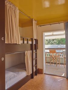 two bunk beds in a room with a balcony at Halse Lodge Noosa Heads in Noosa Heads