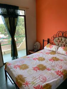 a bedroom with a bed and a window with a view at Complejo Turístico Tierra Dorada in Manta +7 photos