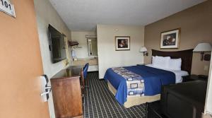 a hotel room with a bed and a television at Americas Best Value Inn Mount Vernon in Mount Vernon