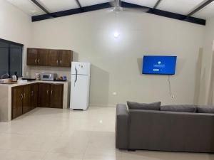 a kitchen with a refrigerator and a couch in a room at San Antonio Home in San Antonio