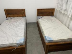 two beds sitting next to each other in a room at N28 Negombo in Negombo +1 photo