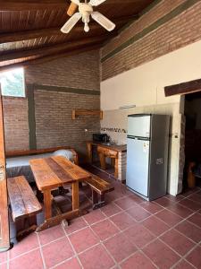 a kitchen with a wooden table and a refrigerator at Cabañas La Cautiva in Tanti