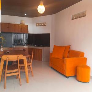 a living room with a table and a couch at kenanga Villa Ubud in Ubud