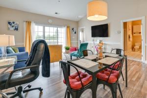 a living room with a table and chairs at Charming Condo with Balcony, 1 Mi to UNC Charlotte! in Charlotte
