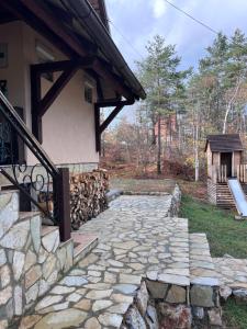 a stone walkway in front of a house at Vikendica Martinović in Divčibare +26 photos