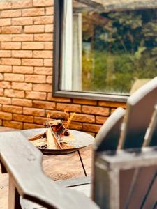 a wooden table with a plate of food on it at Maria Rita dos Canyons in Praia Grande +11 photos