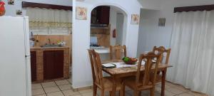 a kitchen with a table and chairs and a kitchen with a refrigerator at Puerto Plata Home in San Felipe de Puerto Plata
