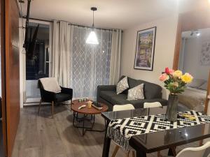 a living room with a couch and a table at Puerto Montt Centro - Diagonal Germania con estacionamiento in Puerto Montt