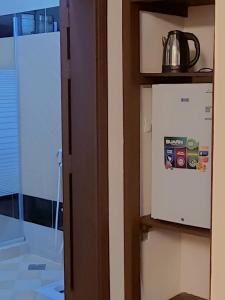 a refrigerator with a kettle on top of it at نزل الزائر 2 in Al Madinah