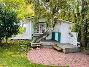 a small house with a tree on the porch at 2 person holiday home in RAMDALA in Trummenas +20 photos
