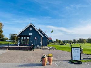 a building with a playground and a sign in front of it at 2 person holiday home in RAMDALA in Trummenas