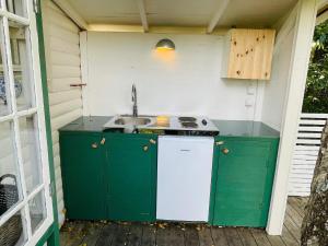 an outdoor kitchen with a sink and a stove at 2 person holiday home in RAMDALA in Trummenas