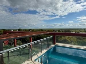 a view from the balcony of a house with a swimming pool at Apart -Hotel Rio Manso "Habitación 22" in Victoria