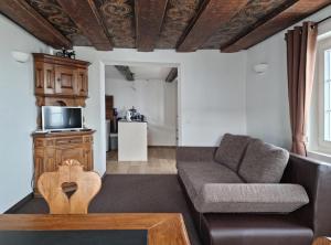 a living room with a couch and a table at Haus Am See Mühlruh in Horn