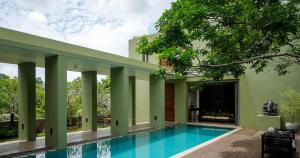 a pool in the backyard of a house at Villa 98 in Malabe