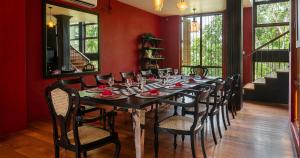 a dining room with a long table and chairs at Villa 98 in Malabe