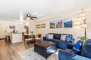 a living room with a blue couch and a table at Fall Line 107 condo in Telluride